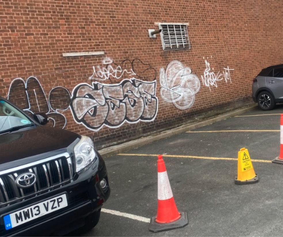 Graffiti on wall by car park