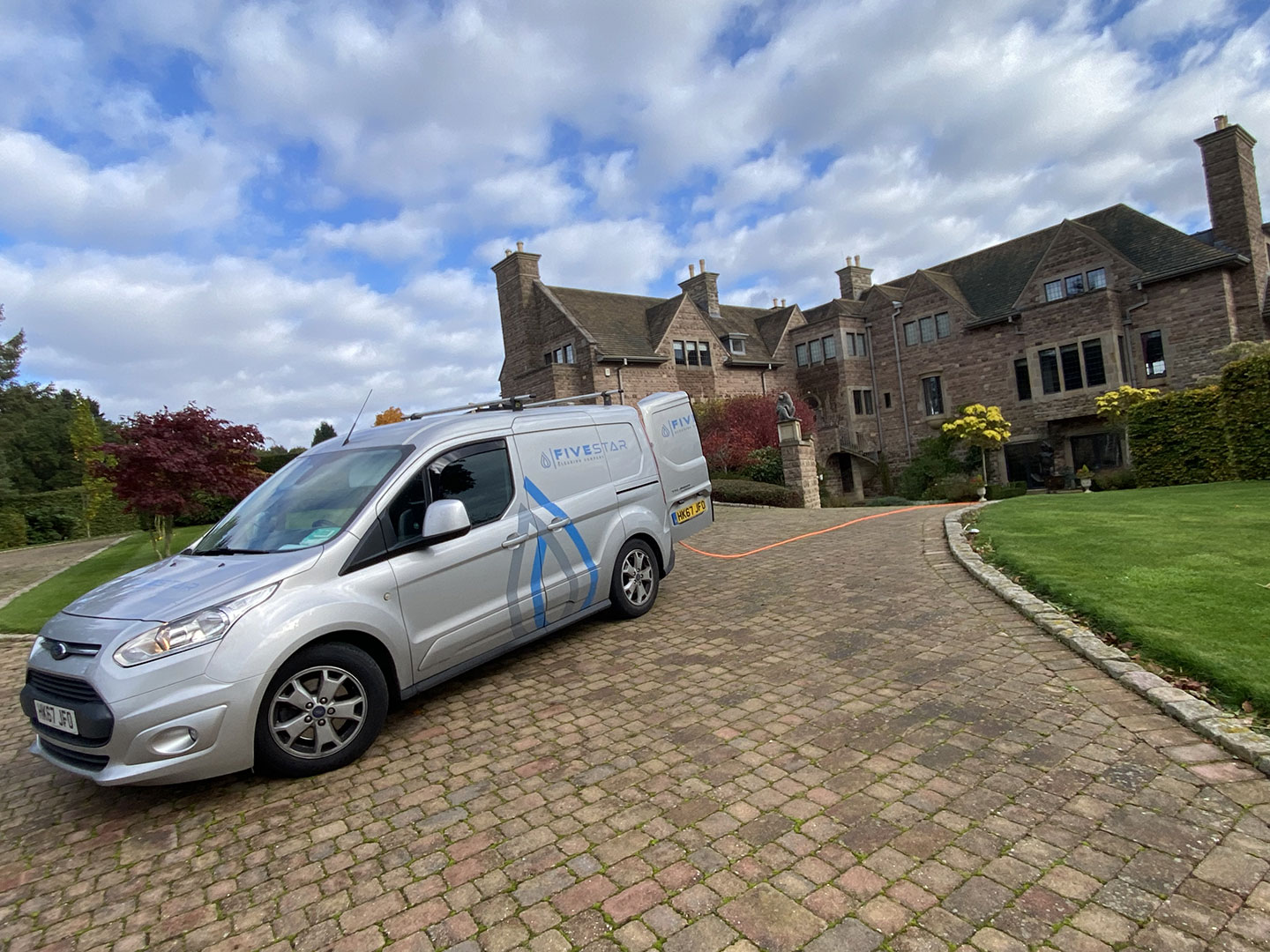 Five Star Cleaning Company van on drive of large residential property
