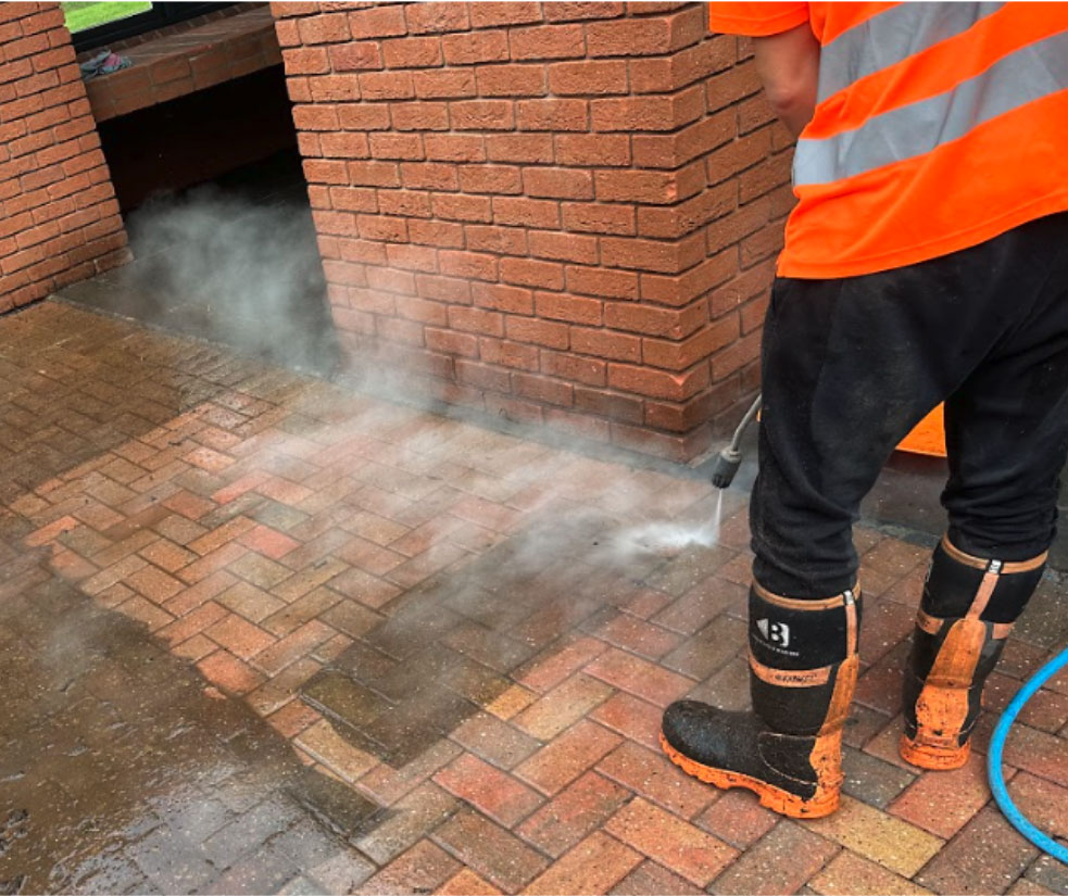 Steam pressure washing brick flooring